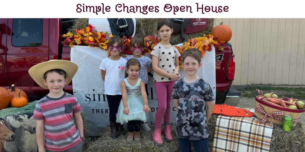 A group of kids posing in front of a fall-themed photo booth. Above the image is the text "Simple Changes Open House"