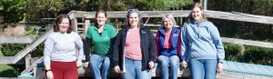 The staff of Simple Changes pose in front of the outdoor mounting ramp. From left, Kylie Vanhove, Jenny Spain, Jennifer Frazier, Corliss Wallingford, Jenna Chappell.